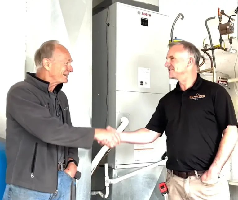 Justin the owner of SureTech Heating & Cooling shaking a happy customers hand after a complete full hvac system install in Vancouver Wa